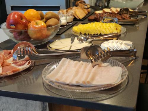 a buffet with plates of food on a table at El Patio de los Jazmines Boutique-House in Consuegra