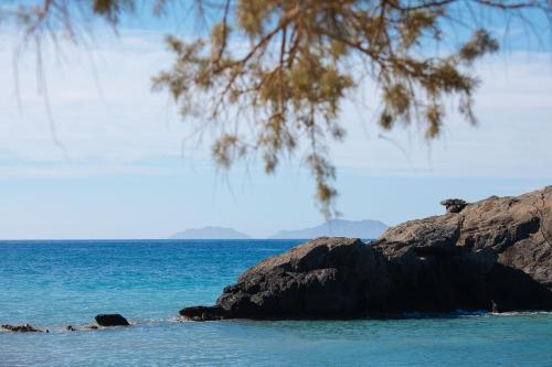 a view of the ocean with rocks in the water at Dionyssos Rooms Preveli Crete in Preveli