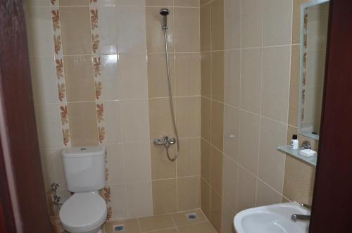 a bathroom with a shower with a toilet and a sink at Marka Hotel in Antalya