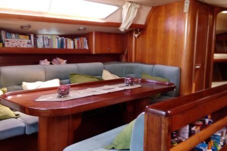 a living room with a table and a couch at Velero MissTick,Gibsea 47'2 in Puerto Calero