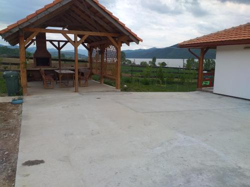 a wooden pavilion with a table and a grill at Villa Rustica in Gornea