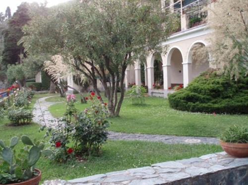 a house with a garden with flowers and plants at Elegant and Sea View Excelsior Apartment in Levanto