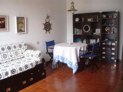 a living room with a table and chairs and a couch at Elegant and Sea View Excelsior Apartment in Levanto
