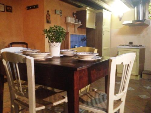 a dining room table with bowls and plates on it at Antica Dimora San Girolamo in Licata
