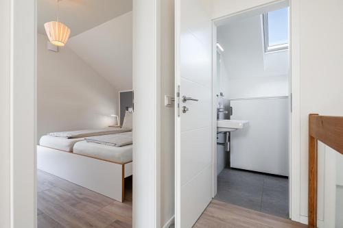 a small bedroom with a bed and a bathroom at Ferienhaus Rügen-Relax in Trent