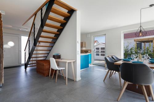 a dining room with a staircase and a table and chairs at Ferienhaus Rügen-Relax in Trent