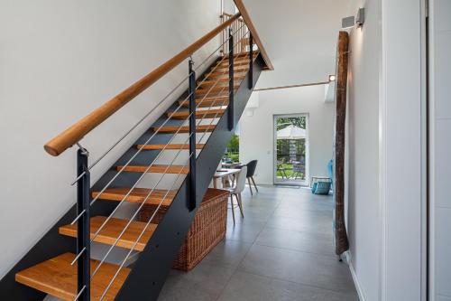 a staircase in a home with white walls and a hallway at Ferienhaus Rügen-Relax in Trent