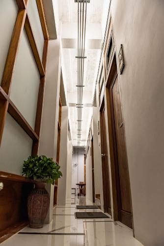 a hallway in a building with a plant in a vase at U Chiangkhan in Chiang Khan