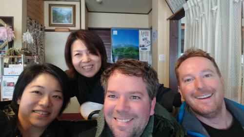 a group of people posing for a picture at Tabataya in Myoko