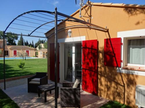 a patio with an arbor and a house at Mas'Xime in Saint-Rémy-de-Provence