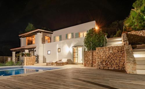 a villa with a swimming pool at night at Blue Hill House, King-of-Hill Villa with amazing scenery, sunset & sea view in San Jose