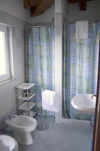 a bathroom with a toilet and a sink and a shower at alla Gledizia in Udine