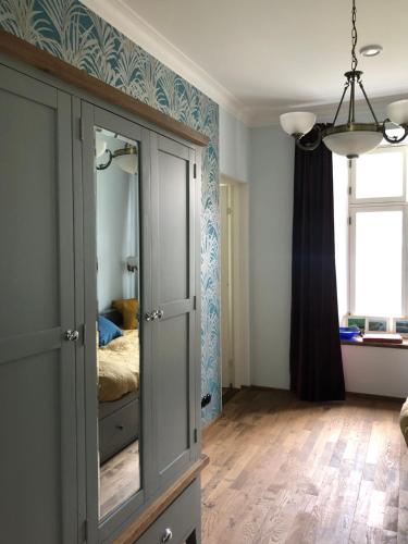 a bedroom with a cabinet with a bed in it at Lõuna 6-3 Apartement in Pärnu