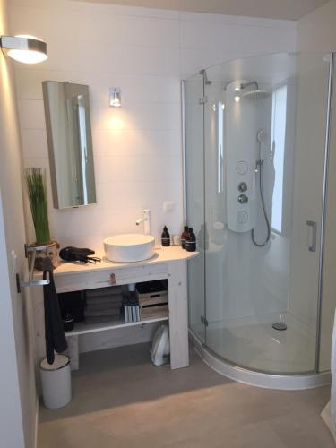 a bathroom with a sink and a shower at Suite 336 in Menen