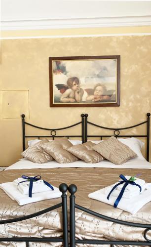 a bedroom with two beds with blue bows on them at LA TERRAZZA SUL CORSO City Center in Agrigento