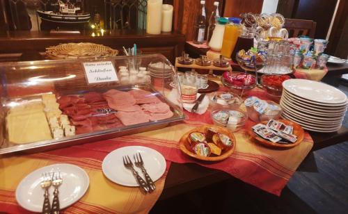 a table with a buffet of food and plates at Zum Fehmelbauer in Karlstadt