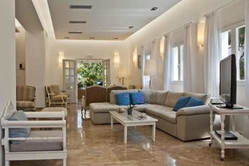 a living room with a couch and a table at Kamari Hotel in Platis Yialos Mykonos
