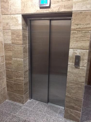 a metal elevator door in a building at Megi Luxury Apartments in Pomorie