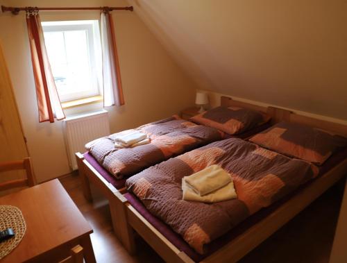 Una cama o camas en una habitación de Penzion U Vyhlídky