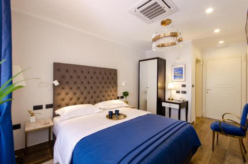 a bedroom with a large bed with a blue blanket at Villa Brandestini in Pula