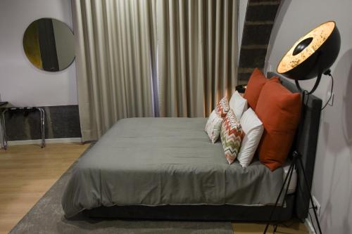 a bedroom with a bed with pillows on it at Casa das Arcadas in Ponta Delgada