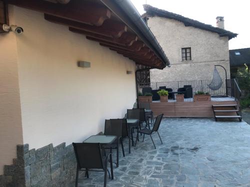 a group of tables and chairs on a patio at B&B La Maison D' Amelie Camere e Appartamenti in Fenis