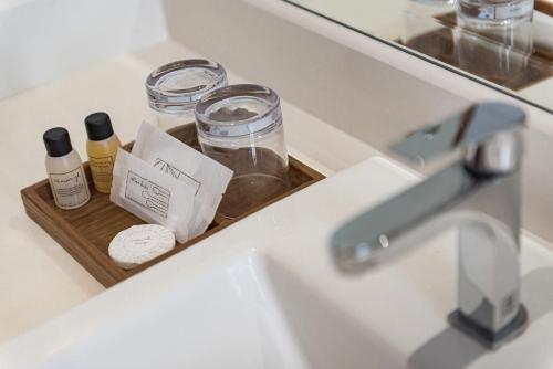 a bathroom sink with a tray with bottles of essential oils at U Chiangkhan in Chiang Khan
