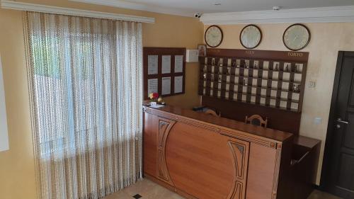 a court room with a large window with two clocks on the wall at Готель "Валерія" in Novoselytsya