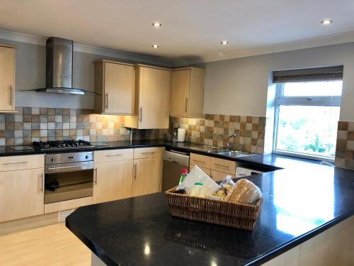 a kitchen with a counter with a basket on it at AB - Top floor 2 bed modern town centre apartment with parking for one vehicle in Stratford-upon-Avon