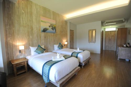 Ένα ή περισσότερα κρεβάτια σε δωμάτιο στο NanSripanna resort