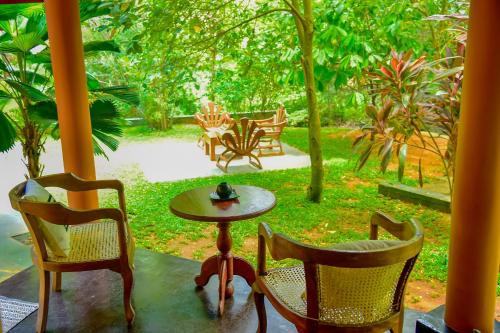 a table and two chairs and a table and chairs at Richards Cabanas in Tissamaharama