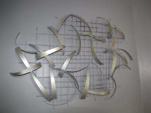 a metal heart shaped sculpture on a wall at Ashmira Guest House in Weymouth