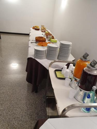 a long table with plates of food on it at Albergo Ristorante Terme in Acquasanta Terme