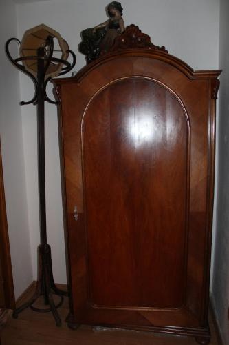 a wooden wardrobe and a lamp in a room at Penzion St. Florian Příbor in Příbor