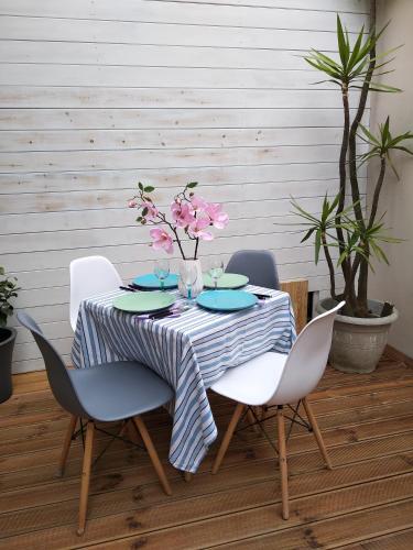 a dining room table with a blue and white striped table cloth at Luxurious bungalow in Ipsos beach in Ýpsos