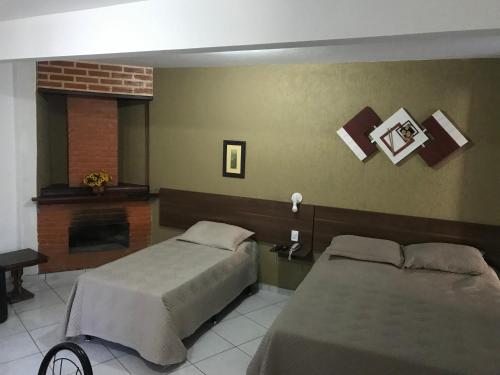 Ένα ή περισσότερα κρεβάτια σε δωμάτιο στο Hotel Halloween Inn Penedo