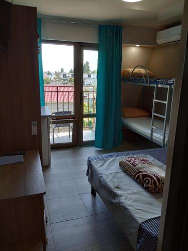 a room with two bunk beds and a balcony at La Kosta Zatoka in Zatoka