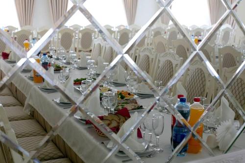 a long table with plates of food and drinks on it at Готель "Валерія" in Novoselytsya