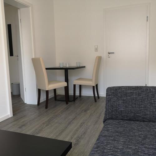 a living room with a table and two chairs at Haus Worch in Juist