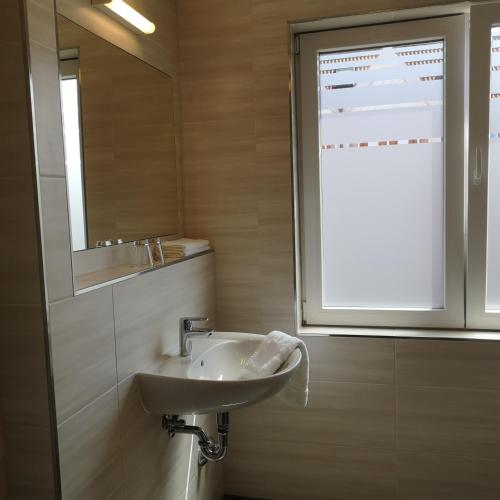 a bathroom with a sink and a window at Haus Worch in Juist