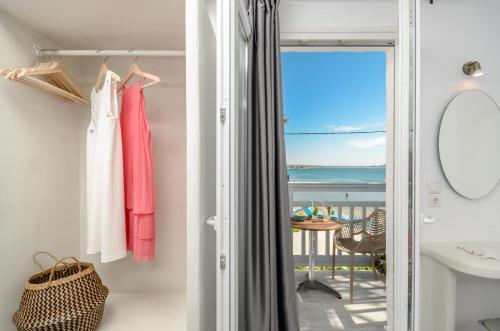 a bathroom with a view of the ocean at Prestige on the beach in Naxos Chora