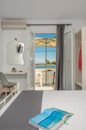 a room with a table with a view of the ocean at Prestige on the beach in Naxos Chora