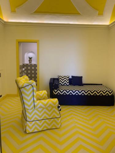 a living room with a couch and a chair at Imperati Suites by Alcione Residence in Positano