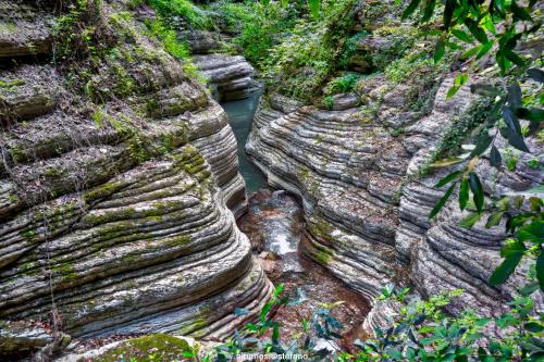 a rock wall with a river running through it at Albergo Ristorante Terme in Acquasanta Terme