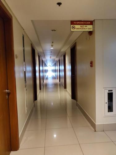 a long hallway in a building with a sign on it at Shell Residence Manila in Manila