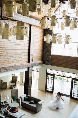 a woman in a wedding dress walking in a living room at Sola Hotel and Sola Bed & Breakfast in Laoag