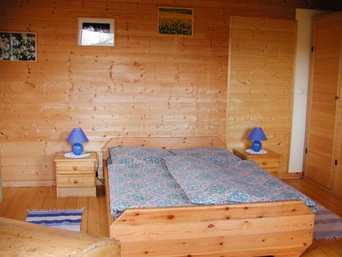 a bedroom with a bed and two blue lamps at Haflingerhof Heed in Kuhstorf