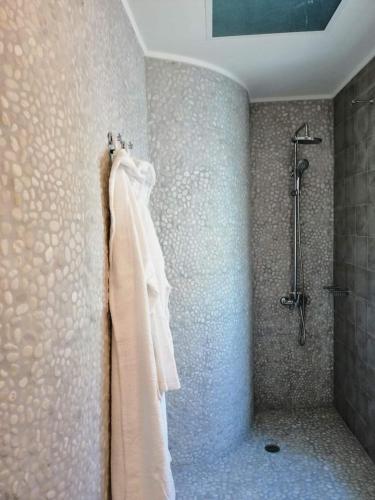 a bathroom with a shower and a towel hanging on a wall at 1920 in Finikounta