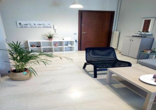 a living room with a chair and a table at Karditsa Home Sweet Home 80 τ.μ in Kardítsa
