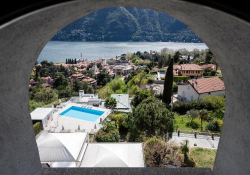a view from an archway of a house and a body of water at Hotel Asnigo in Cernobbio